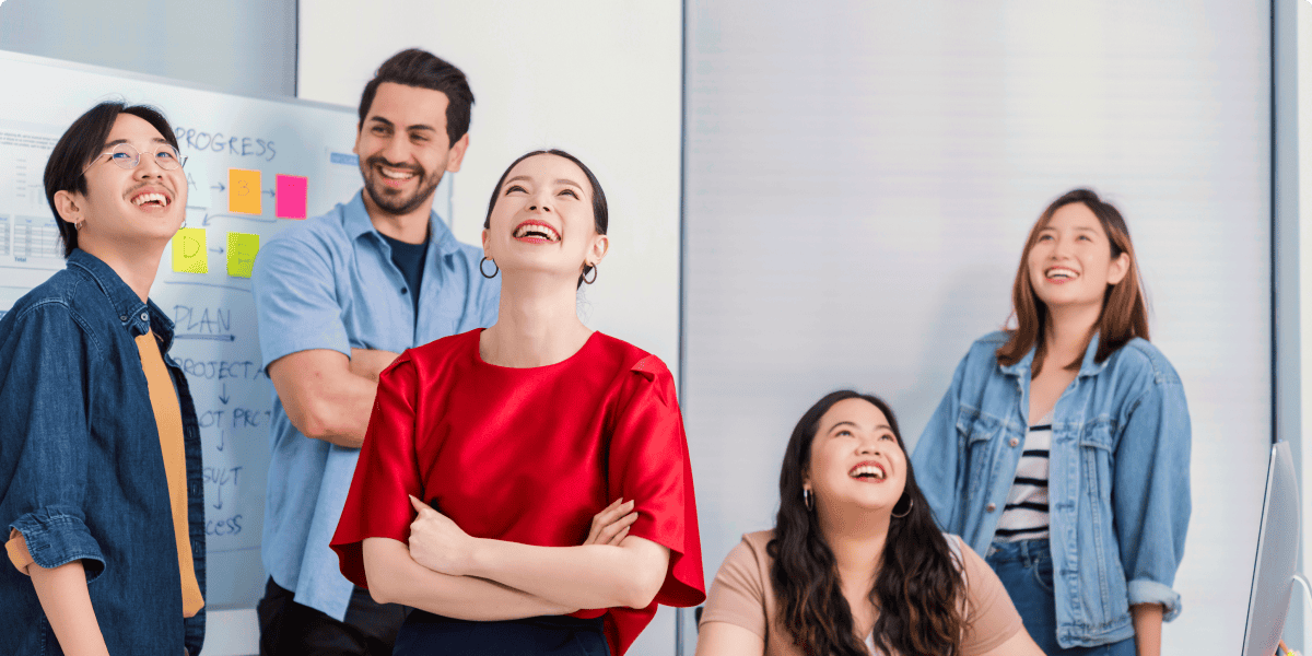 Diverse team collaborating in a modern office environment at Abmax Agency.